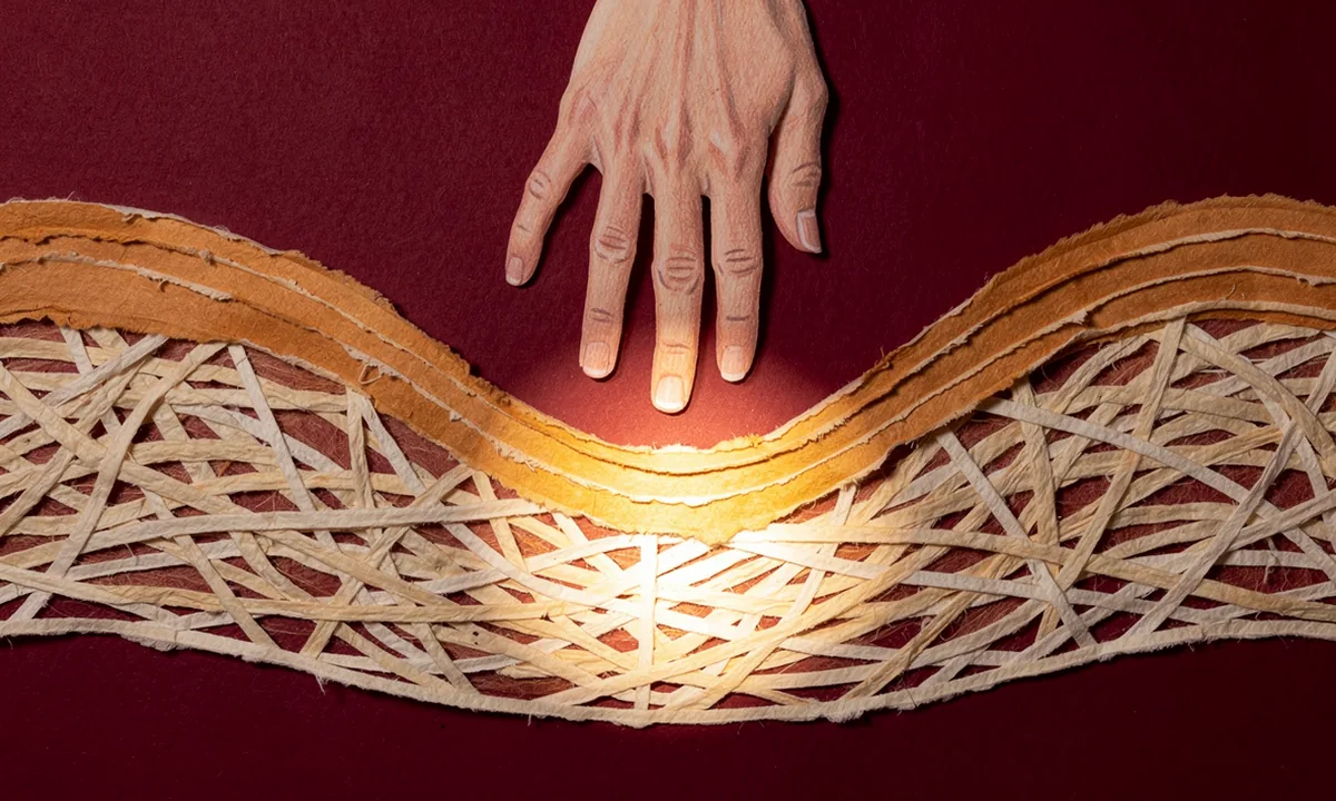 A cut-paper illustration shows a hand above layered skin with woven fibres below the surface